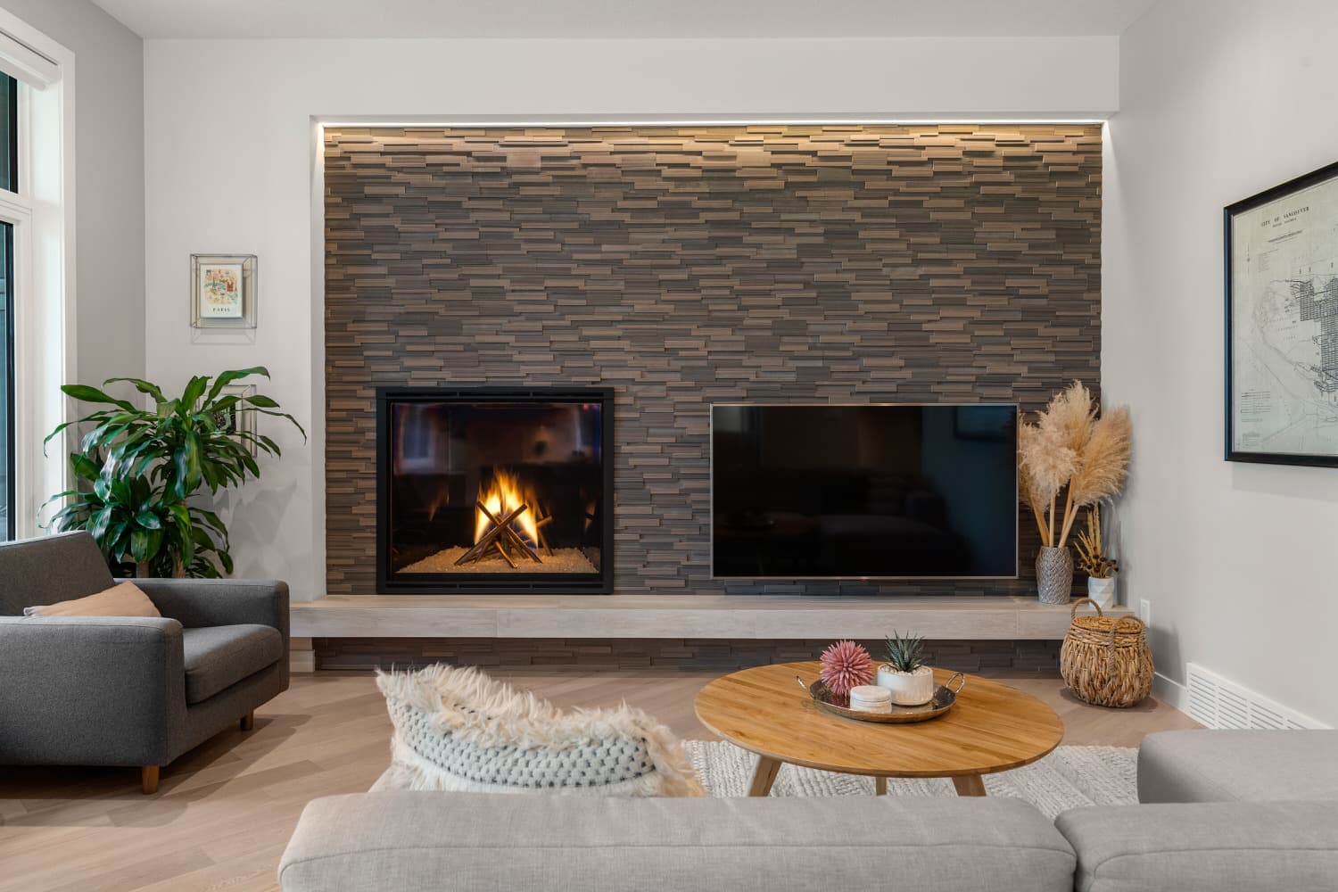 Living room with stacked-stone fireplace and herringbone floors