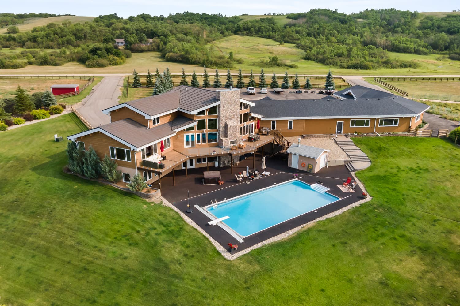 Aerial view of acreage property with pool and outbuildings