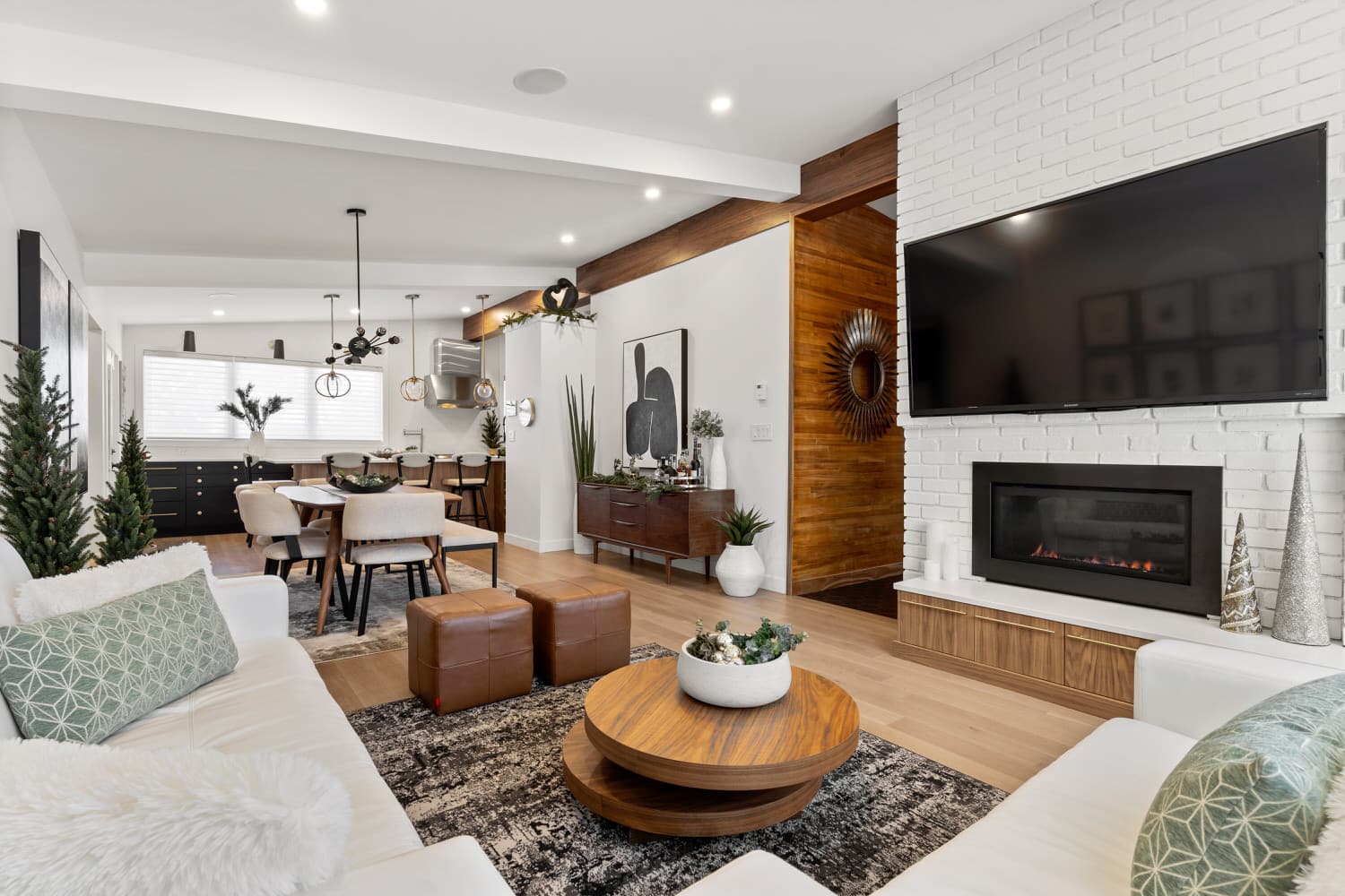 Open-concept living room with fireplace and walnut accents