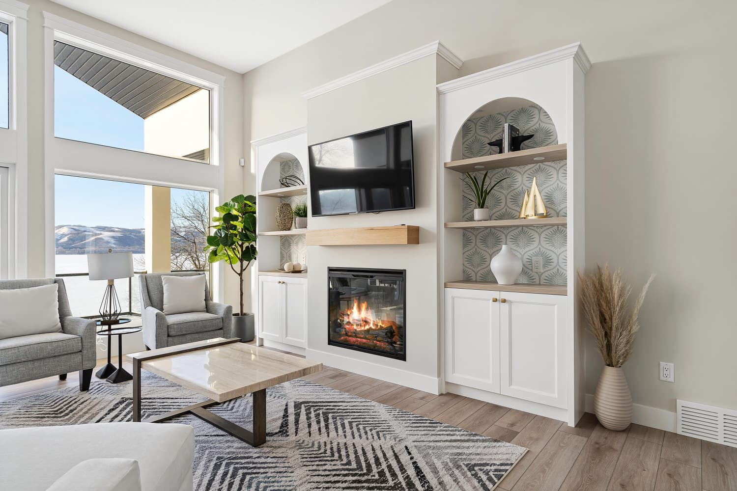 Bright living room with built-in shelving and gas fireplace