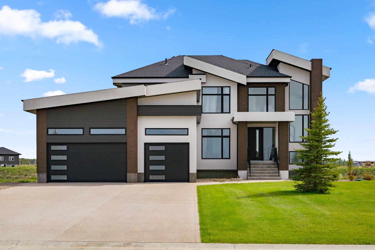 Contemporary two-storey home exterior with triple garage