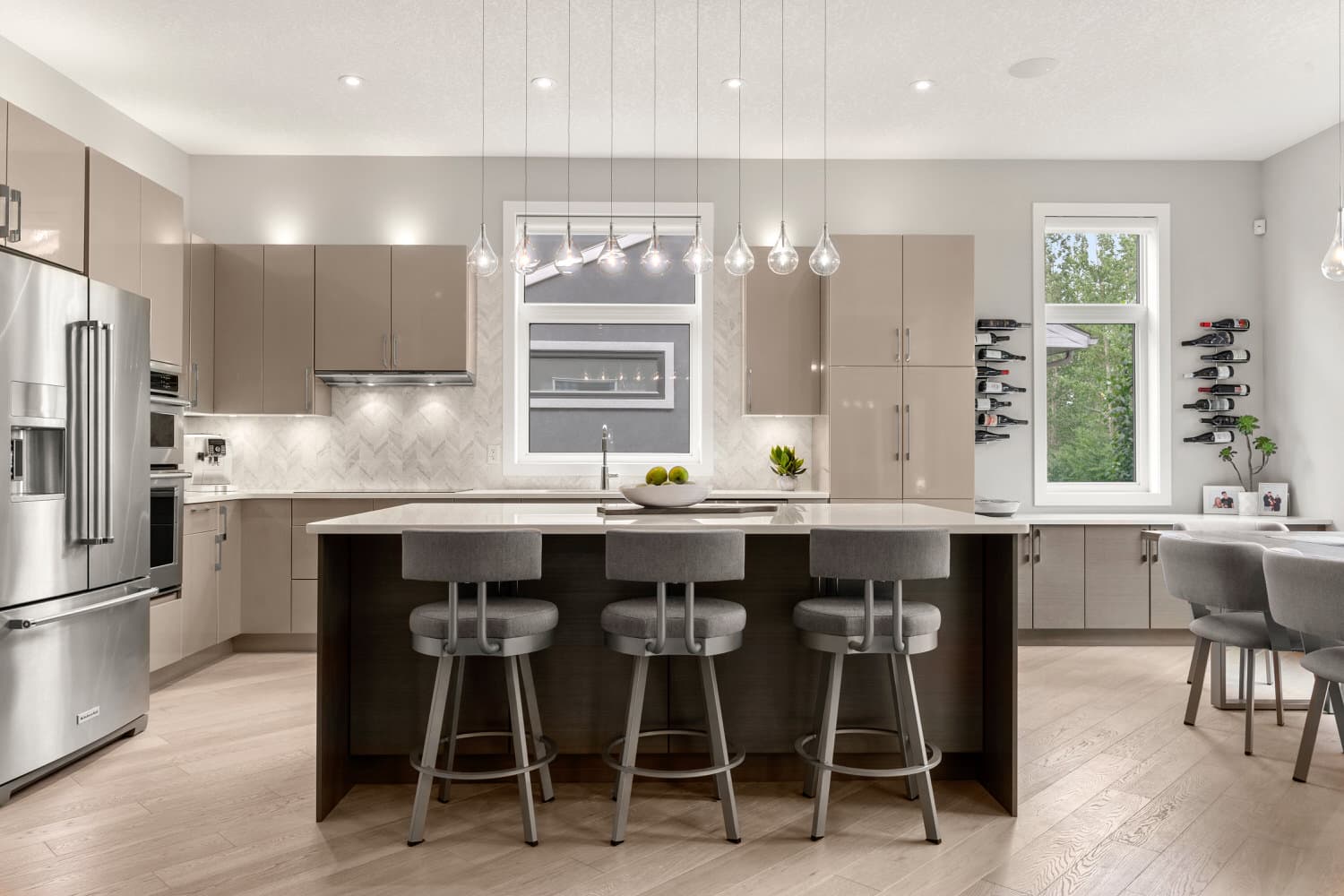 Modern kitchen with taupe gloss cabinets and pendant lighting