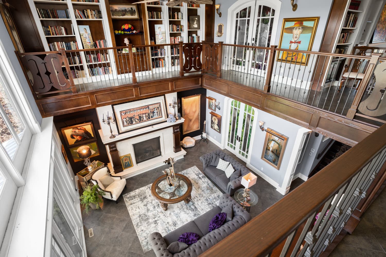 Two-storey great room with library loft and stone fireplace